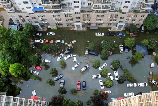 Automobiles are seen flooded at a neighbourhood in Wuhan, Hubei province, China July 9, 2016. The municipality is one of 16 that is part of the country's "sponge cities" pilot program.