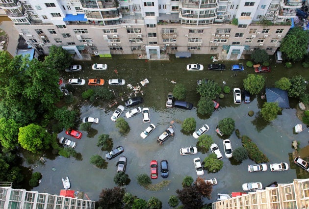 Automobiles are seen flooded at a neighbourhood in Wuhan, Hubei province, China July 9, 2016. The municipality is one of 16 that is part of the country's "sponge cities" pilot program.