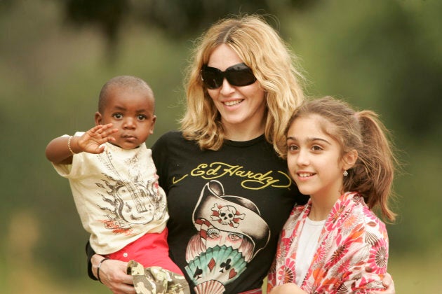 Madonna carries her adopted son David in Lilongwe on April 17, 2007. Her daughter Lourdes is to her right. REUTERS/Siphiwe Sibeko