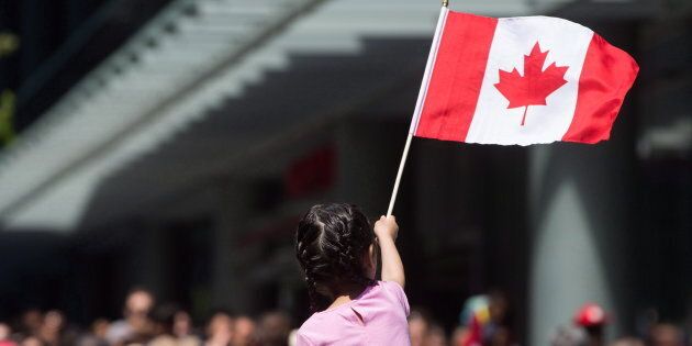 A young girl waves a Canadian flag during Canada Day celebrations in Vancouver, B.C. Canada could be plan B destination for young immigrants in the U.S. who will lose protections when DACA ends in six months.