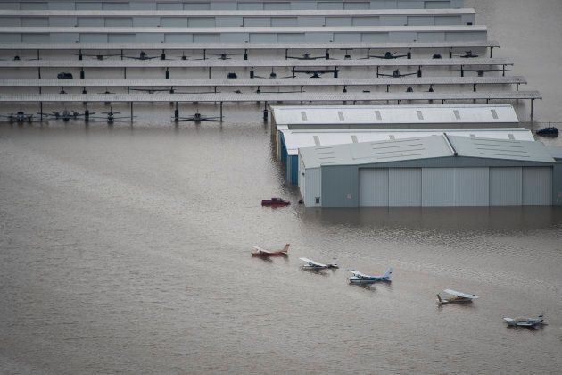 Planes are seen on the runway of West Houston Airport as flood waters surround houses and apartment complexes in West Houston, TX on August 30, 2017.