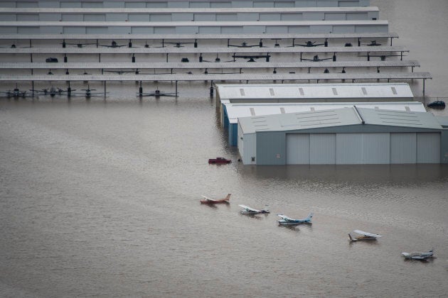 Planes are seen on the runway of West Houston Airport as flood waters surround houses and apartment complexes in West Houston, TX on August 30, 2017.