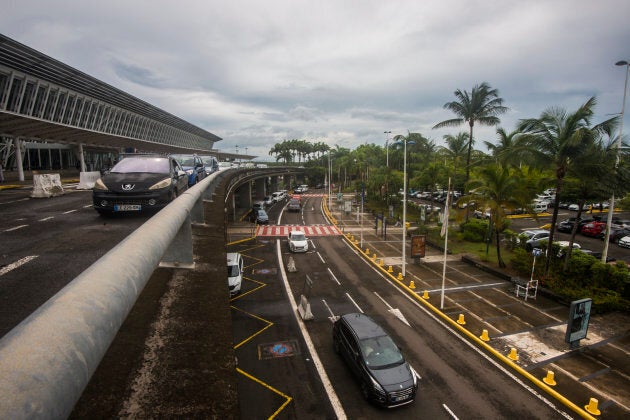 Cars drive past a terminal at the Pole Caraibes international airport in Pointe-a-Pitre, which re-opened on Sept. 6, 2017, after hurricane Irma hit the island.