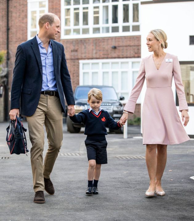 Prince George accompanied by Prince William, Duke of Cambridge, arrives for his first day of school at Thomas's School, where he is met by Helen Haslem, head of the lower school on September 7, 2017 in London. (RICHARD POHLE/AFP/Getty Images)