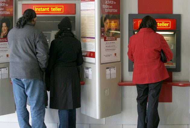 Customers use an automated teller machine (ATM) at a CIBC branch in Mississauga, Ont., February 23, 2007. Consumers are seeing higher borrowing costs in the wake of the Bank of Canada's interest rate hike Wednesday.