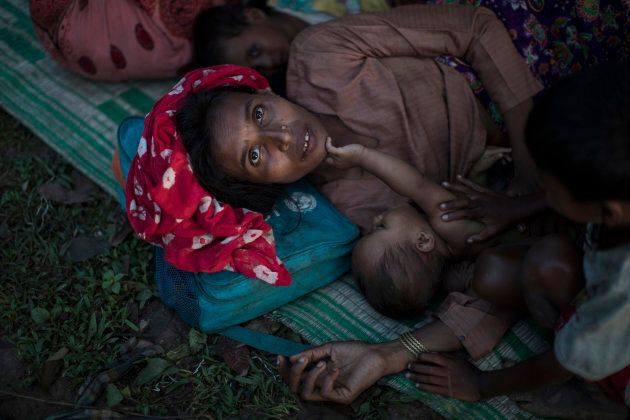 Rohingya Muslim refugees sleep under a makeshift shelter in a clearing in a forest after crossing the border from Myanmar on Sept. 8, 2017 in Gundum, Bangladesh.