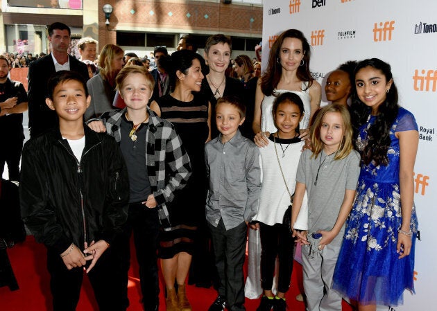 (L-R) Kimhak Mun, Shiloh Jolie-Pitt, Loung Ung, Nora Twomey, Knox Leon Jolie-Pitt, Angelina Jolie, Sareum Srey Moch, Zahara Jolie-Pitt, Vivienne Jolie-Pitt, and Saara Chaudry at 'The Breadwinner' premiere. (Photo by George Pimentel/WireImage)