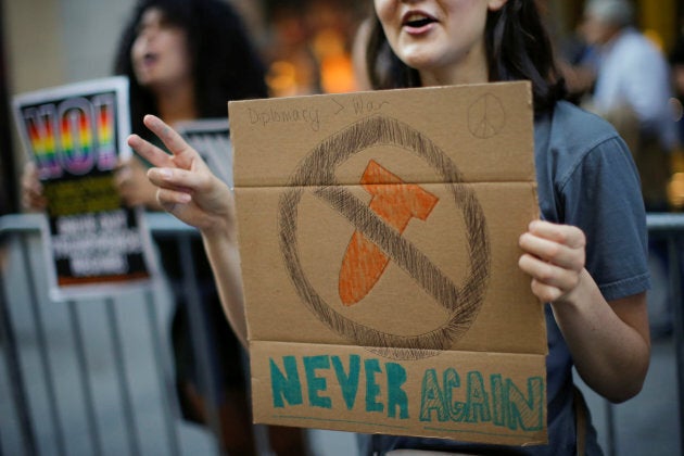 A small group of people protest against the Trump administration and demand immediate diplomatic talks with North Korea to prevent nuclear war, in New York on August 9, 2017.