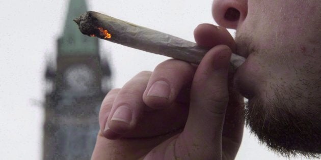 A man lights a marijuana joint as he participates in the 4/20 protest on Parliament Hill in Ottawa, April 20, 2015.