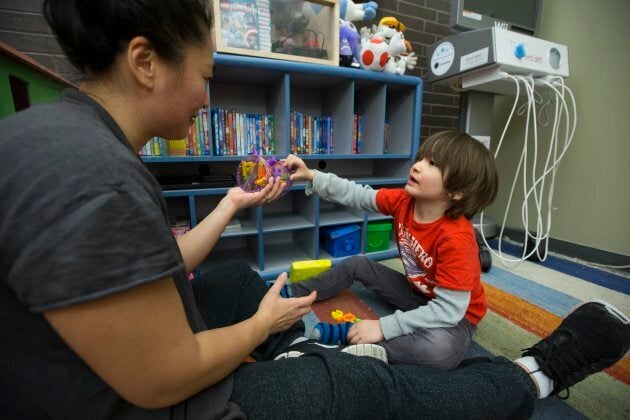 Ting Chan (left) and her son Tristan Chan Wymant, 5, interact together at Holland Bloorview Kids Rehabilitation Hospital. (Rick Madonik/Toronto Star via Getty Images)