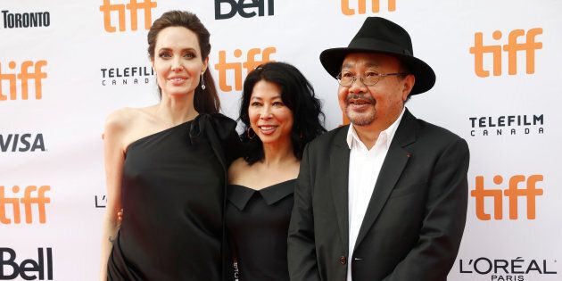 Director Angelina Jolie arrives with activist Loung Ung (C) and director Rithy Panh (R) on the red carpet for the film