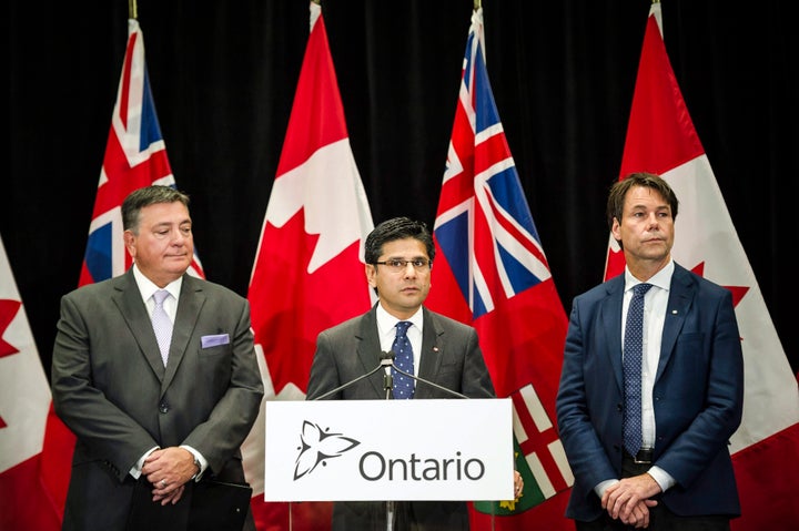 Ontario Attorney General Yasir Naqvi, centre, Minister of Finance Charles Sousa, left, and Minister of Health and Long-Term Care Eric Hoskins speak during a press conference where they detailed Ontario's solution for recreational marijuana sales, in Toronto, Ont. on Friday, Sept. 8, 2017.