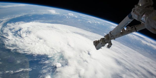 In this handout provided by NASA from the the Earth-orbiting International Space Station, weather system Arthur travels up the east coast of the United States in the Atlantic Ocean near Florida on July 2, 2014 in space. The robotic arm of the Space Station Remote Manipulator System or Canadarm2 is seen at upper right.