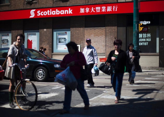 People walk by a Scotiabank in Chinatown in Toronto, April 30, 2009.