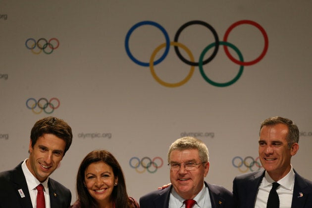 International Olympic Committee member and co-chairman of Paris 2024 Tony Estanguet, Mayor of Paris Anne Hidalgo, IOC President Thomas Bach and Mayor of Los Angeles Eric Garcetti pose for photo after a news conference during the 131st IOC session in Lima on Wednesday.