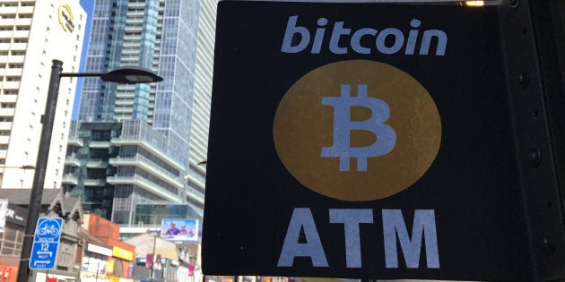 A sign is seen outside a business where a Bitcoin ATM is located in Toronto, Ont., June 3, 2017.