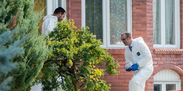 Police forensic investigators enter a home in Saint-Eustache, Que. on Sept.15, 2017. Quebec provincial police confirm a woman found dead in suburban Montreal is the mother of a six-year-old boy who is the subject of an Amber Alert.