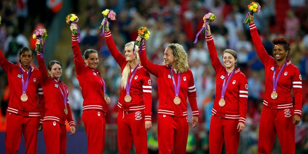 The Canadian team pose with their bronze medals for women's soccer during the victory ceremony at Wembley Stadium during the London 2012 Olympic Games, August 9, 2012. (REUTERS/Brian Snyder)
