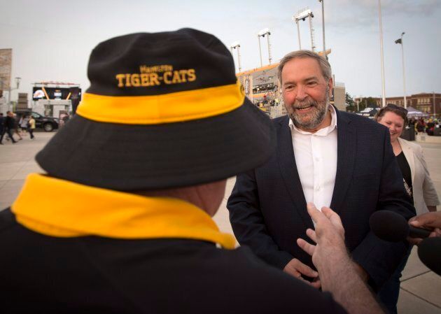 NDP Leader Tom Mulcair speaks with a Tiger-Cats and NDP fan after a media availability to kickoff the party's fall caucus retreat before catching a CFL game in Hamilton, Ont. on Sept. 15, 2017.