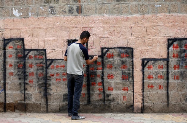 Artist and activist Thiyazen al-Alawi paints a mural on a wall of a hospital as part of a cholera awareness campaign in Sanaa, Yemen, May 23, 2017.