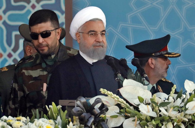 Iranian President Hassan Rouhani sits among senior army staff as he delivers his speech during the annual military parade marking the anniversary of the outbreak of its devastating 1980-1988 war with Saddam Hussein's Iraq, on September 22, 2017 in Tehran.