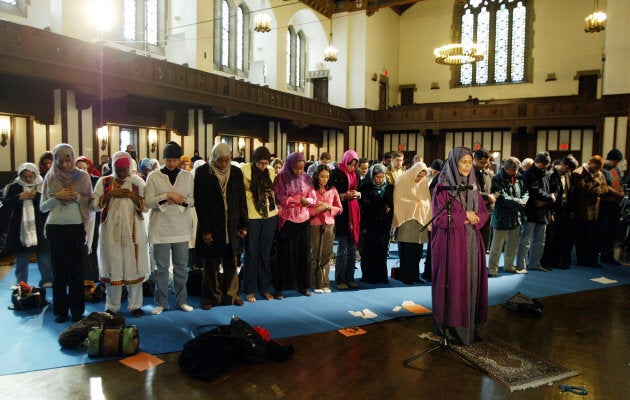 Dr. Amina Wadud (center right) leads a group of women at the first public, mixed-gender Muslim prayer service that was held in New York City, March 18, 2005. Dr. Wadud, is a professor of Islamic studies at Virginia Commonwealth University. The service was held at the Synod House in New York.