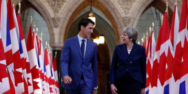 Prime Minister Justin Trudeau and British Prime Minister Theresa May walk in the Hall of Honour on Parliament Hill in Ottawa, Sept. 18.