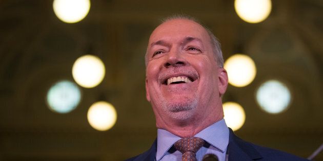 John Horgan reacts outside the gates of the British Columbia legislature building in Victoria, B.C. on May 29, 2017.