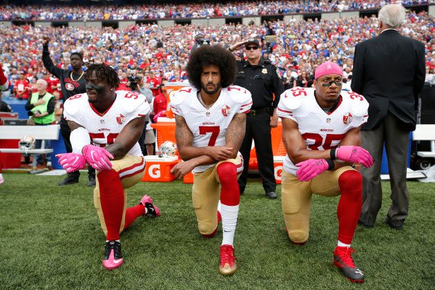Eli Harold #58, Colin Kaepernick #7 and Eric Reid #35 of the San Francisco 49ers kneel in protest on the sideline, during the anthem, prior to a game against the Buffalo Bills at New Era Field on Oct. 16, 2016.