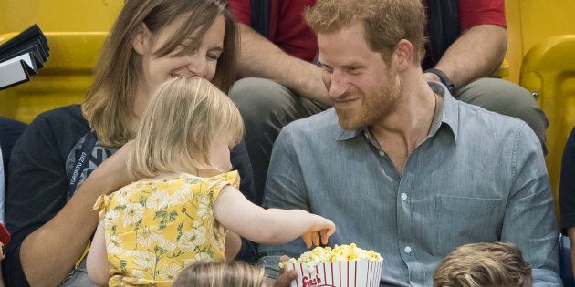 Prince Harry sits with Hayley Henson, left, and her daughter Emily Henson at the Invictus Games in Toronto on Sept. 27, 2017 in Toronto.
