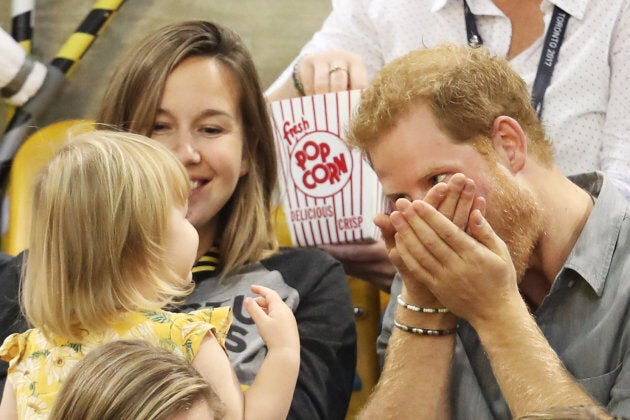 Emily Henson and her mother Hayley Henson sit with Prince Harry at the Sitting Volleyball Finals during the Invictus Games in Toronto on Sept. 27, 2017.