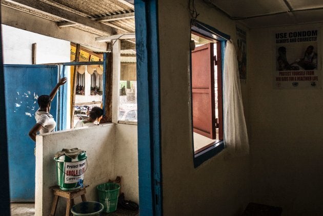 Women stand at the entrance of a clinic in Monrovia, Liberia, on May 2, 2016. Family planning services, like contraceptives and counselling, are available.