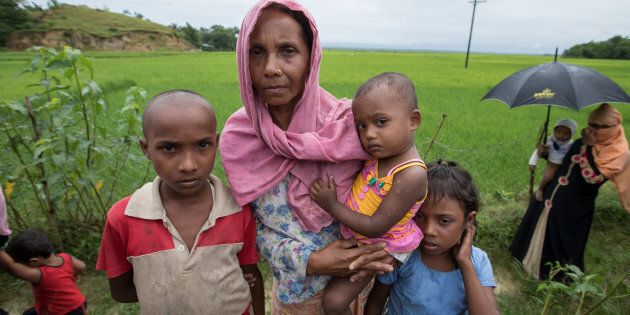 A Rohingya widow whose husband was killed in Myanmar arrives in the Bangladeshi district of Cox's Bazar with her children.