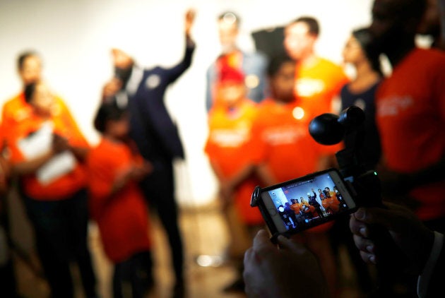 A man livestreams NDP leadership candidate Jagmeet Singh as he speaks at a meet and greet event in Hamilton, Ont. on July 17, 2017.