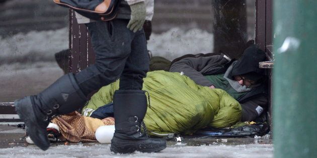 A homeless man sleeps in a doorway in Vancouver's Downtown Eastside, Dec. 19, 2016.