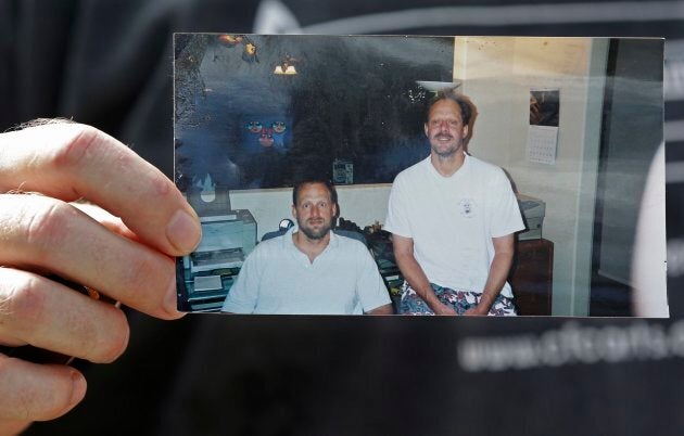 Eric Paddock holds a photo of him and his brother, Stephen Paddock outside his home on Monday.