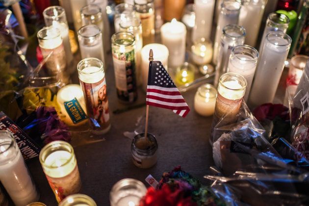 A U.S. flag is placed in the middle of flowers and candles at a vigil that was held for the victims along the Las Vegas Strip a day after 59 people were killed and more than 500 wounded at the Route 91 Harvest Country Music Festival on Oct. 2, 2017, in Las Vegas, NV.