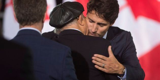 Prime Minister Justin Trudeau is embraced by survivor Nate Leipciger during a ceremony for the National Holocaust Monument in Ottawa on Sept. 27, 2017.