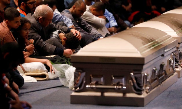 A young mourner is comforted during a funeral ceremony on Feb. 3, 2017 for three of the victims of the deadly shooting at the Quebec Islamic Cultural Centre.