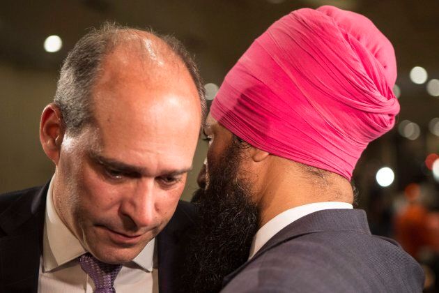 Jagmeet Singh speaks to Guy Caron as they arrive to hear the first ballot results for the NDP leadership race in Toronto on Oct. 1, 2017.