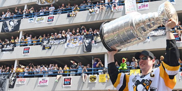Sidney Crosby of the Pittsburgh Penguins hoists the Stanley Cup during the Victory Parade and Rally on June 14, 2017 in Pittsburgh, Pa.