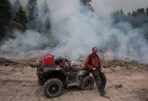 B.C. Wildfire Service firefighter Jordain Lamothe takes a brief break while conducting a controlled burn to help prevent the Finlay Creek wildfire from spreading near Peachland, B.C., on Sept. 7, 2017.