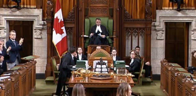 Members of the House of Commons stand and applause after Assistant Deputy Speaker Anthony Rota warned member to respect the Queen and Governor General.