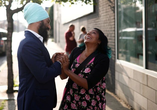 New Democratic Party federal leadership candidate Jagmeet Singh shakes hands with a woman at a meet and greet event in Hamilton, Ont. on July 17, 2017.