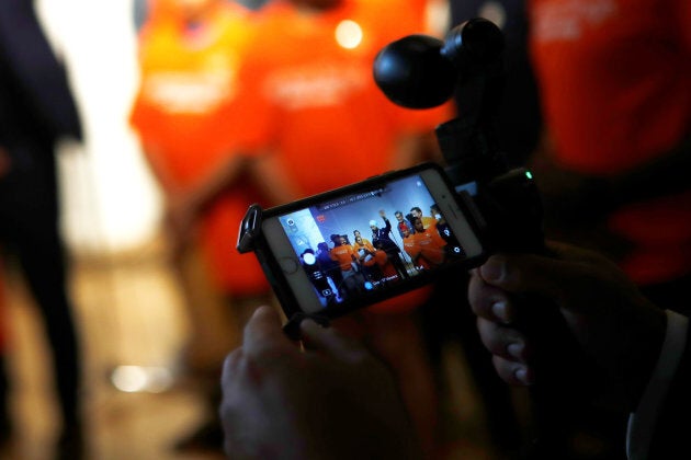 A man live streams New Democratic Party federal leadership candidate Jagmeet Singh as he speaks at a meet and greet event in Hamilton, Ont. on July 17, 2017.