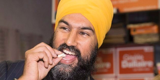 NDP Leader Jagmeet Singh samples a famous Lac-St-Jean curd cheese during a campaign visit for local candidate Gisele Dallaire on Oct. 10, 2017 in Alma, Que.