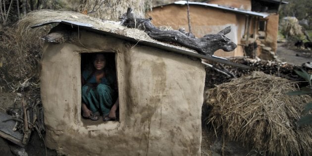 Uttara Saud, 14, sits inside a chaupadi shed in the hills of Legudsen village in Achham District in western Nepal in this Feb. 16, 2014 file picture.