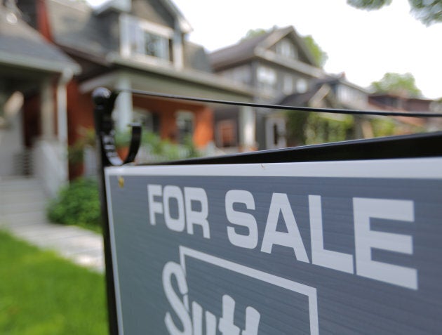 A sign advertises a house for sale as Canada's central bank announced its first interest rate hike in nearly seven years, on a residential street in midtown Toronto, July 12, 2017.