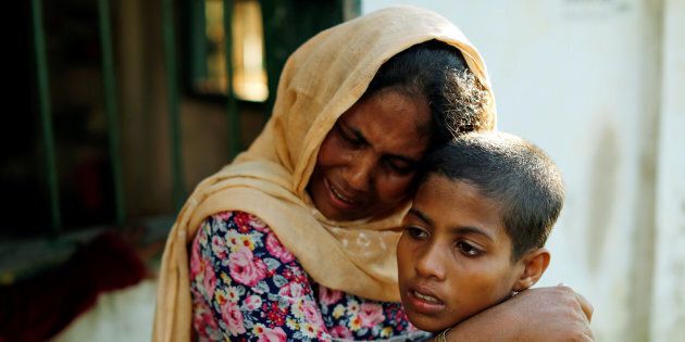 Rashida, 10, and her mother, who survived after a boat capsized, while five of their family members are among the many who died or have gone missing while fleeing Myanmar, react at a local madrasa in Teknaf, Bangladesh, Oct. 16, 2017.