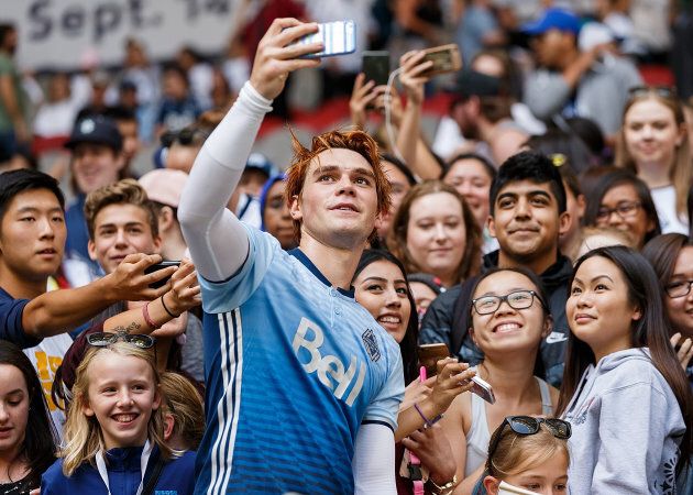 Actor KJ Apa takes a selfie with fans after the Legends And Stars: Whitecaps FC Charity Alumni match at BC Place on September 16, 2017 in Vancouver. (Andrew Chin/Getty Images)